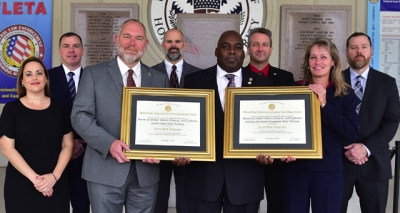 ATF staff holding the FLETA accreditation certificate