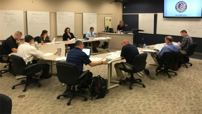 Members of the curriculum review committee review materials for the Assessor Training Program Members of the curriculum review committee review materials for the Assessor Training Program