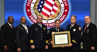 Bureau of Engraving and Printing staff holding the FLETA accreditation certificate