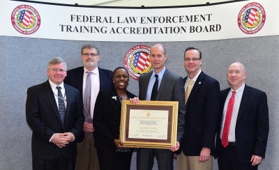 DHS Office of Intelligence staff accepts the certificate of accreditation.