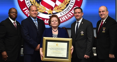 Treasury Inspector General for Tax Administration staff holding the FLETA accreditation certificate