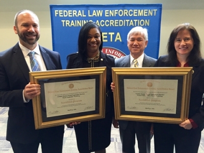 Members from the United States Postal Inspection Service with the certificates for reaccreditation for their programs