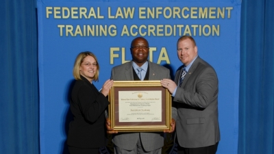 Dept. of Veterans Affairs Law Enforcement Training Center staff present their reaccreditation certificate