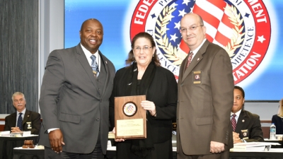 FLETA Board Chair, Dr. James Ward (left) and FLETA Executive Director Joseph Collins (right) present Dr. Molly Wankel the 2018 FLETA Team Leader Recognition Award